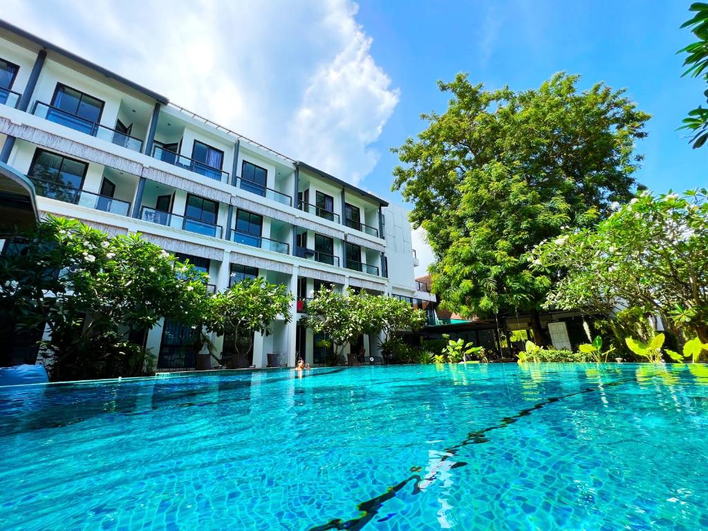 a large swimming pool in front of a building at Z&Z Resort in Rawai Beach