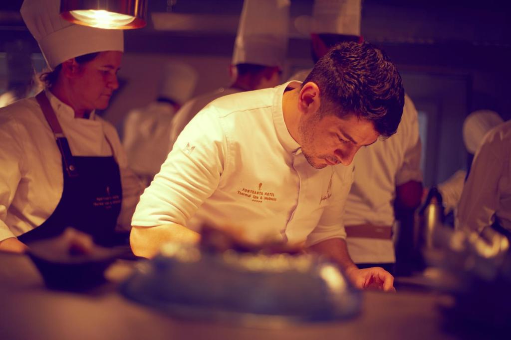 a group of chefs in a kitchen preparing food at Fontsanta Hotel Thermal & Spa - Adults Only in Colònia de Sant Jordi