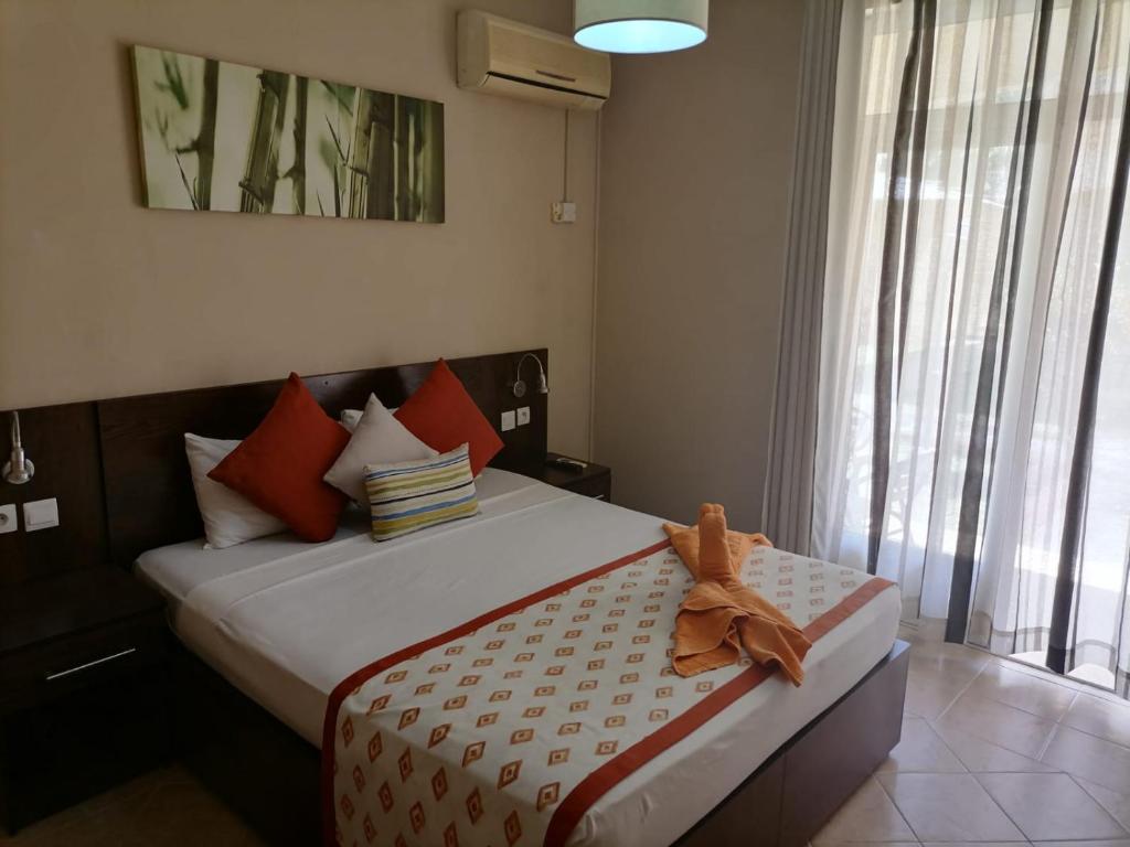 a bedroom with a bed with a teddy bear sitting on it at Le Choisy Mauritius in Mont Choisy