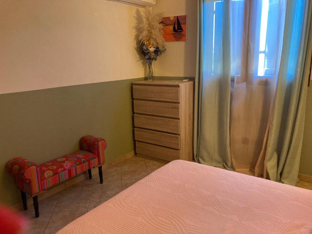 a bedroom with a bed and a chair and a dresser at B&B Macchia Verdata avec piscine in Monacia-dʼAullène