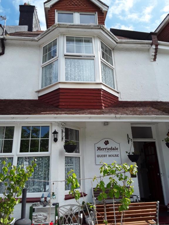 a house with a sign on the front of it at Merriedale Guest House in Paignton