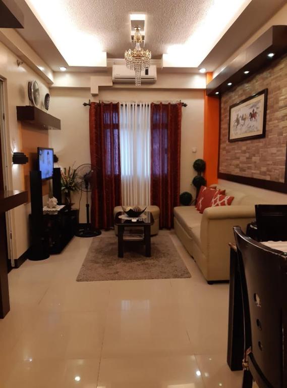 a living room with a couch and a table at Sarasota Residential Resort cluster 4 Unit 6C & 6L by Manny Newport Blvd, across NAIA T3 & near Resorts World Manila, Pasay City in Manila