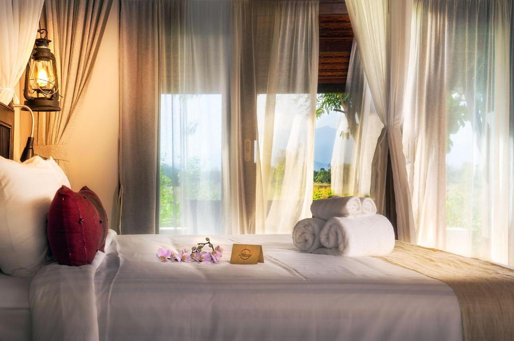 Postel nebo postele na pokoji v ubytování Sriwilai Sukhothai