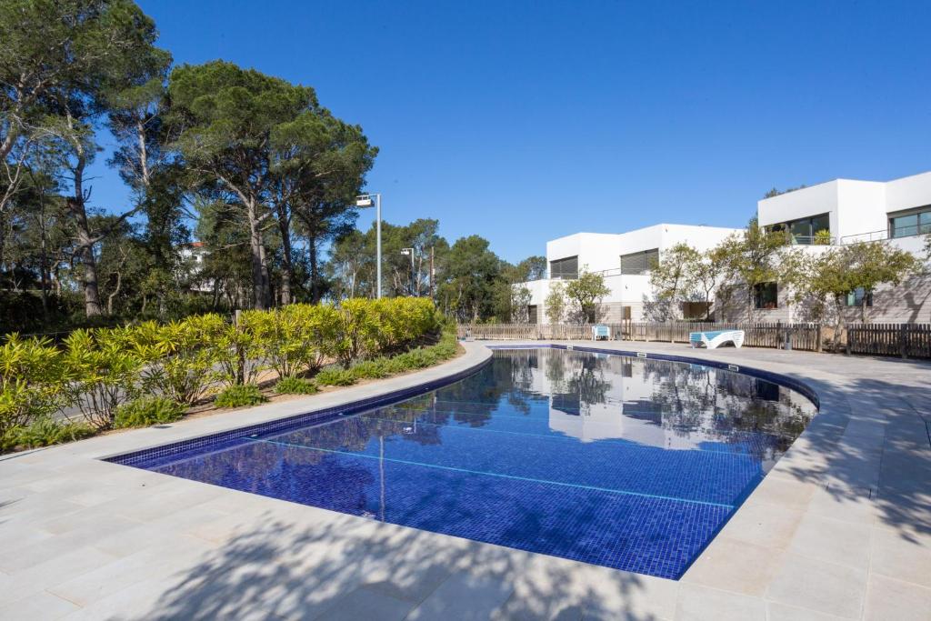 a swimming pool in the middle of a building at VILLA MANAVA in Llafranc