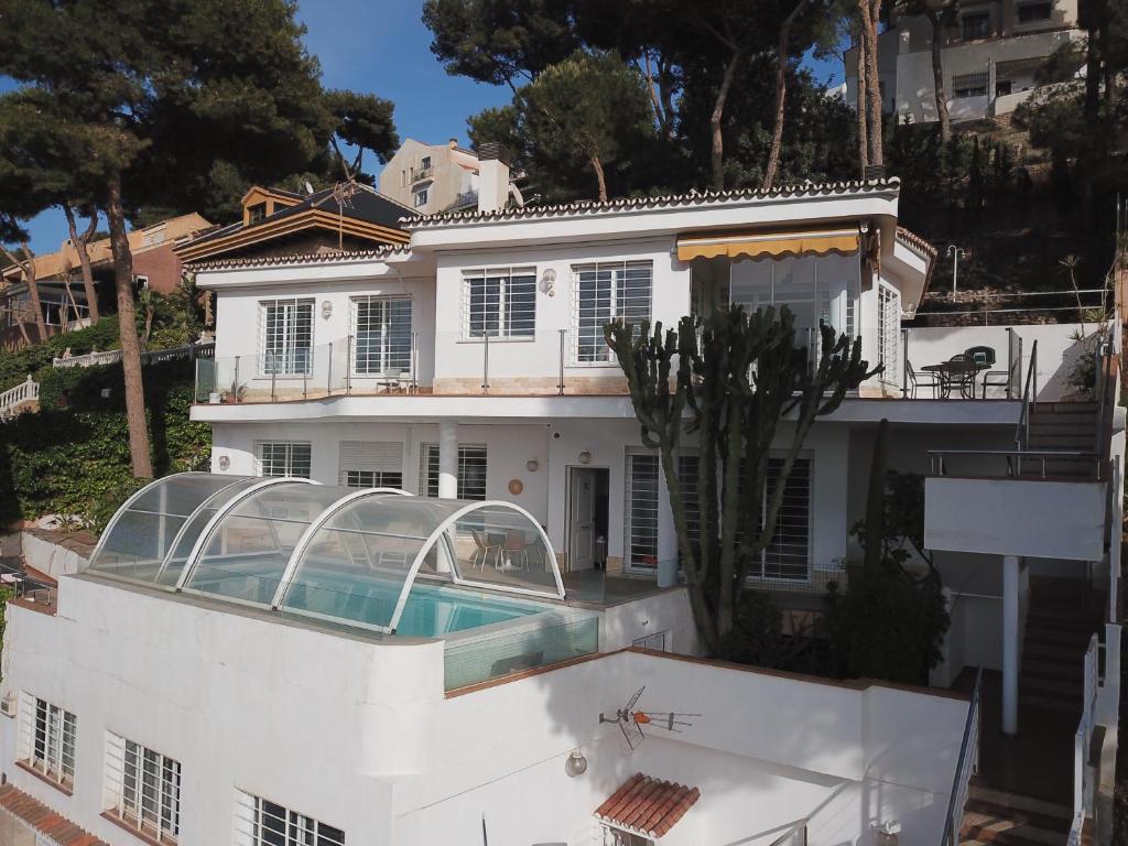 una casa blanca con piscina frente a ella en LU&CIA Villa Infinity, en Málaga