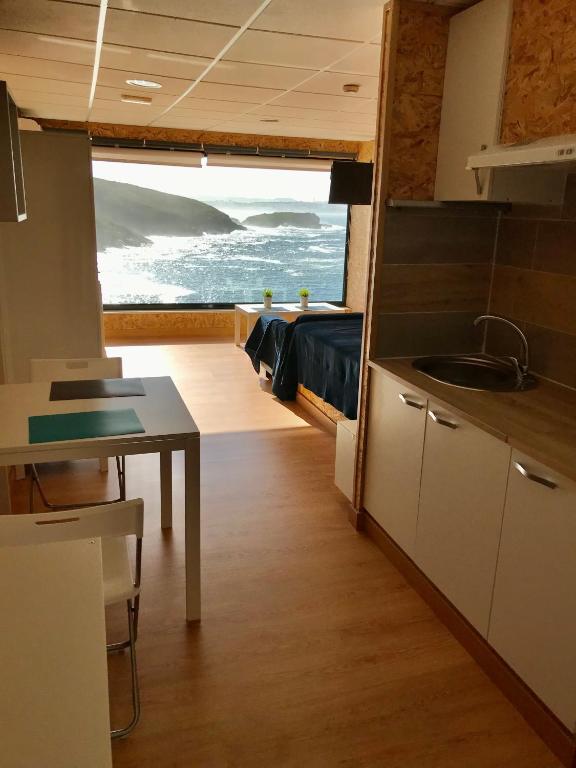 a kitchen and dining room with a view of the ocean at Vistas al mar 4 Canabal in A Coruña