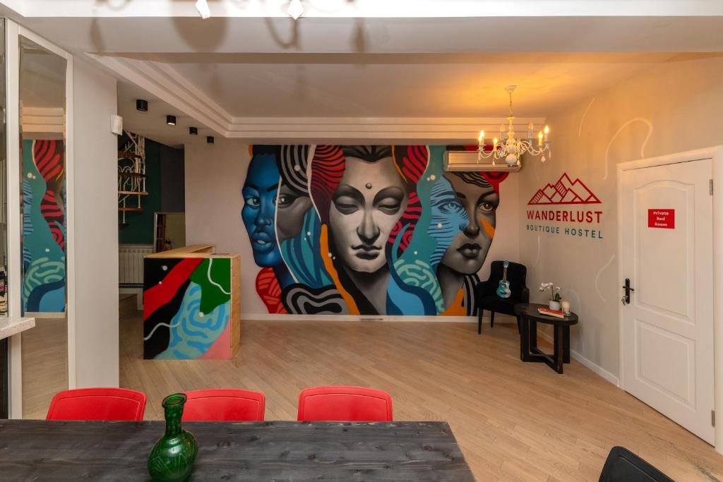 a room with a large mural on the wall at Wanderlust boutique hostel in Almaty