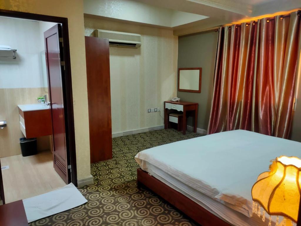 Postel nebo postele na pokoji v ubytování Grand Inn Hotel By Wanasa
