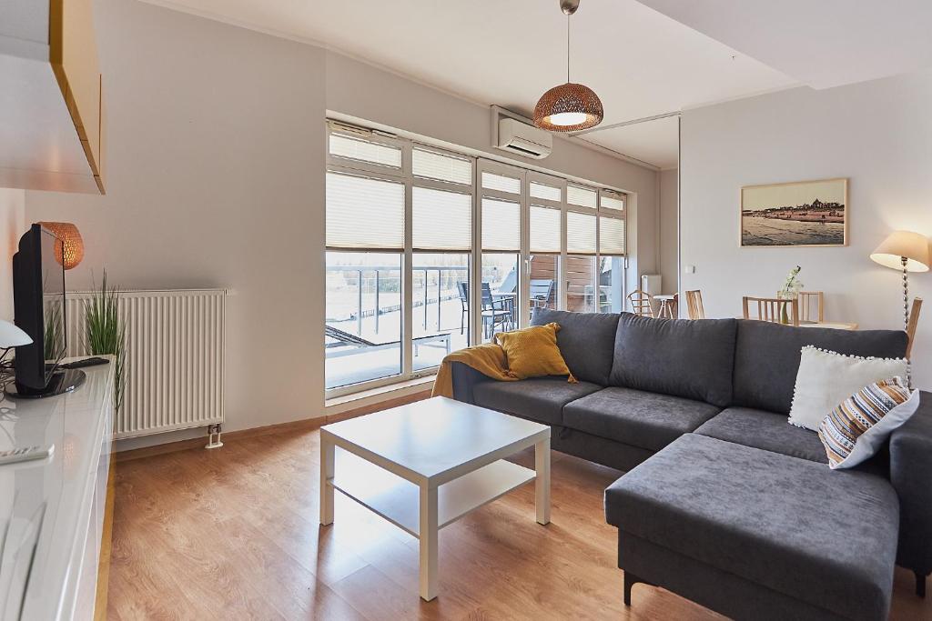 a living room with a couch and a table at Apartamenty Świnoujście Villa Concha in Świnoujście