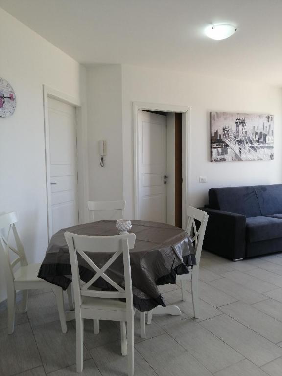 a living room with a table and chairs and a couch at CM HOUSE MARZAMEMI in Marzamemi