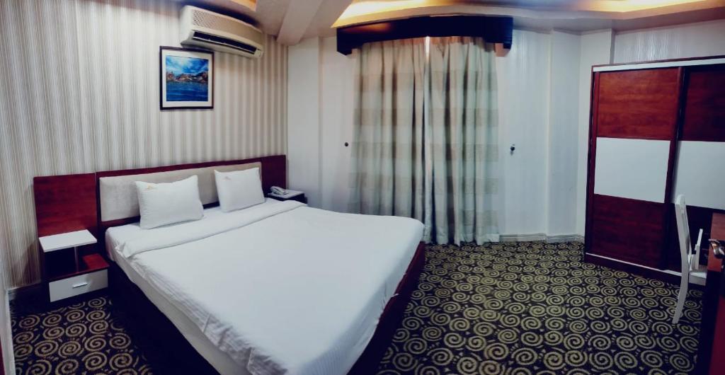 Postel nebo postele na pokoji v ubytování Grand Inn Hotel By Wanasa