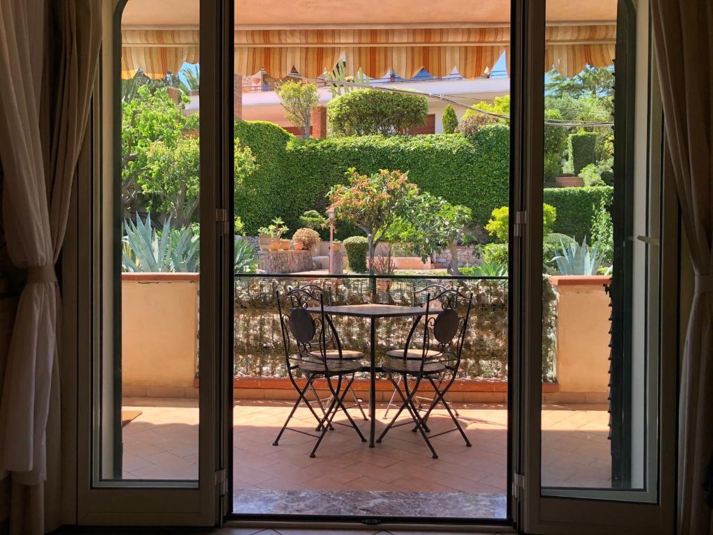 an open door with a table and chairs on a patio at La casa di Marilena in Taormina