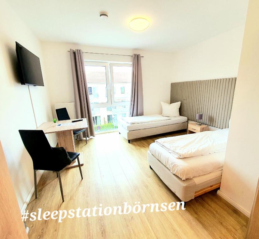 a bedroom with a bed and a desk and a chair at Hotel sleep-station in Börnsen