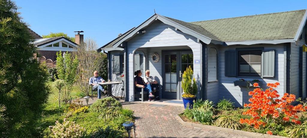 a group of people sitting on the porch of a house at Blockhaus in Gnarrenburg