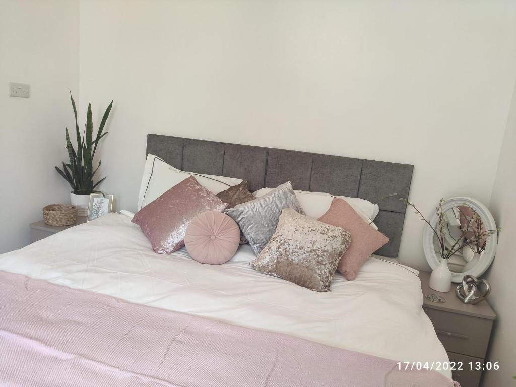 a bed with a bunch of pillows on it at Hale Lodge in London