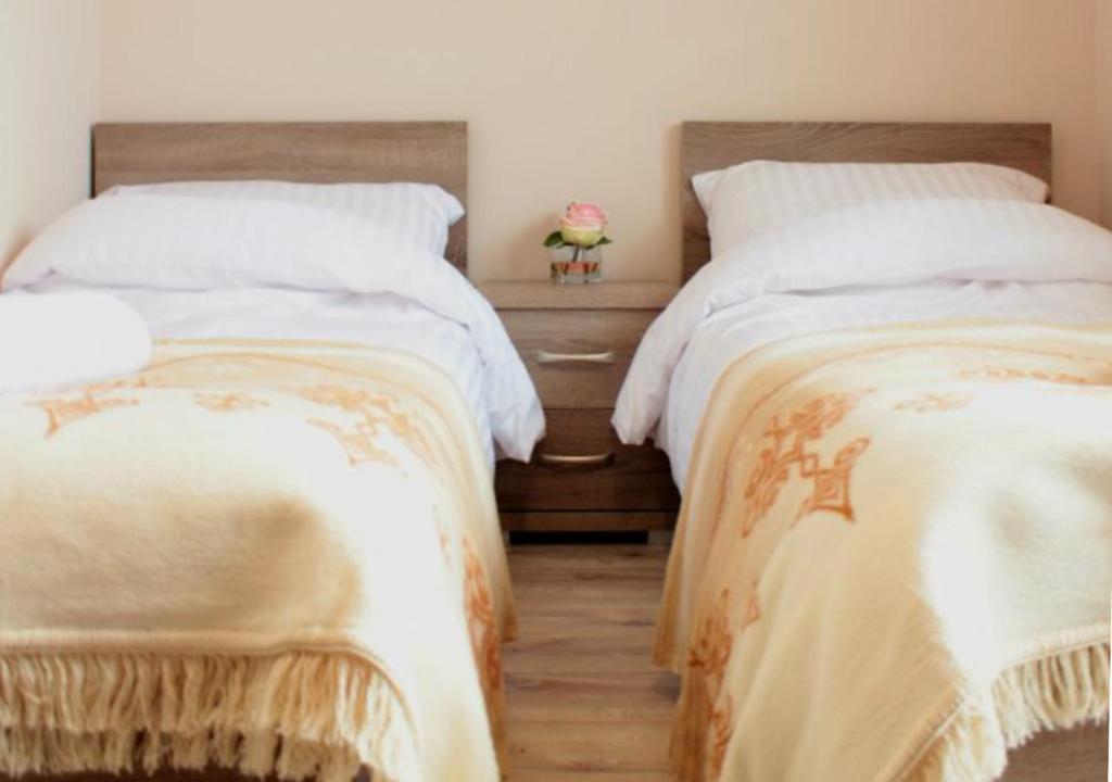 two beds sitting next to each other in a bedroom at Villa TATRIA in Witów