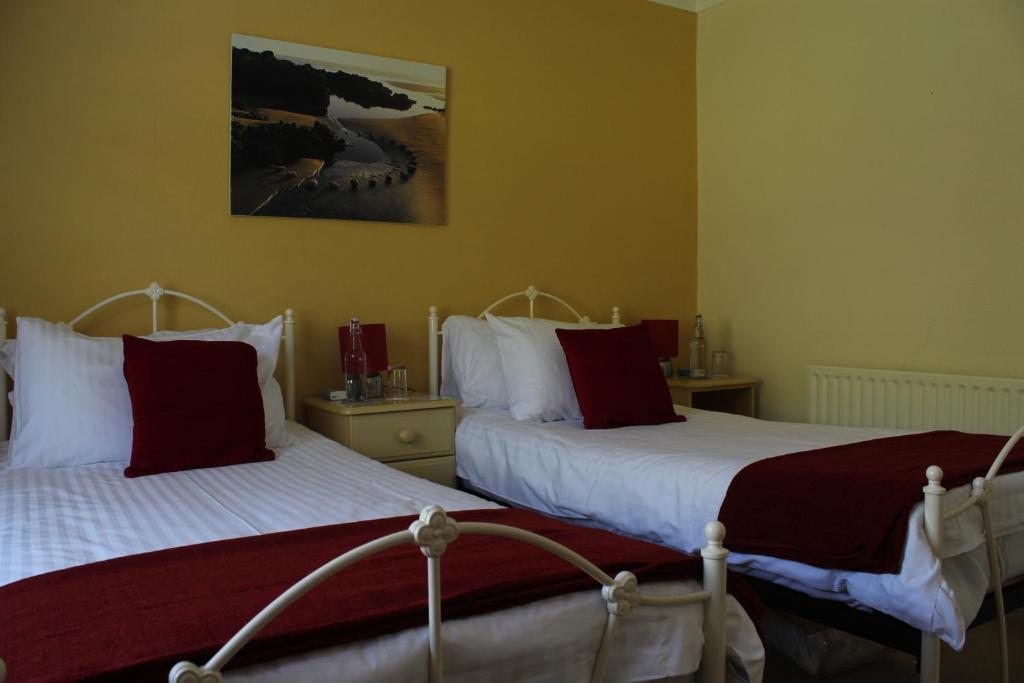 林頓的住宿－隆米德旅館，卧室内两张并排的床