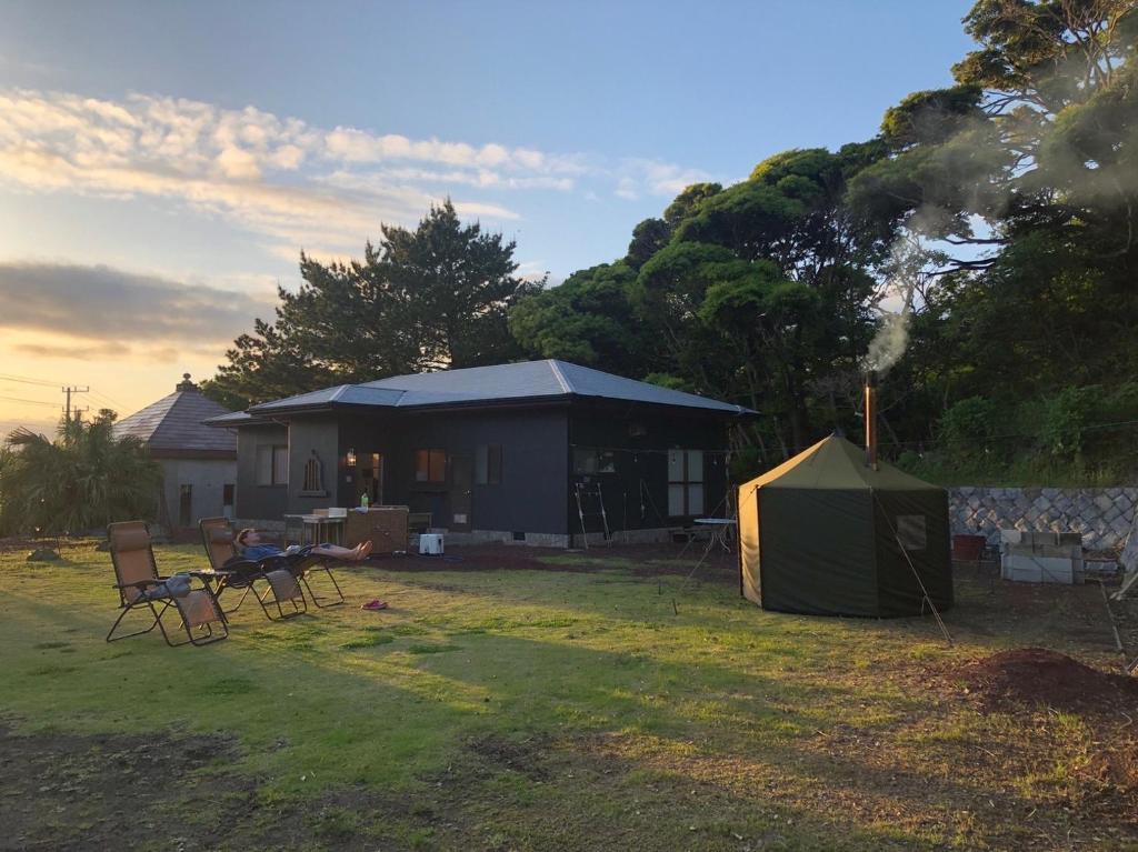 a tent and chairs in front of a house at Big Island Base 一組限定 in Oshima