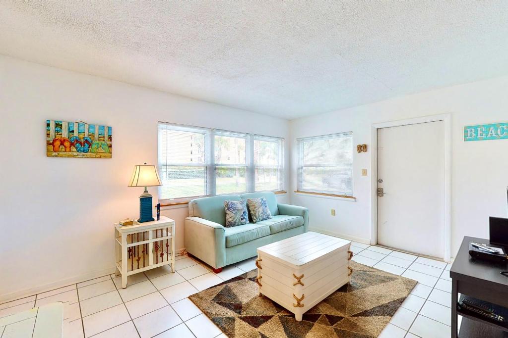 a living room with a couch and a table at The Simple Life in Cocoa Beach