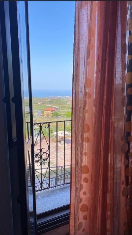 a room with a window with a view of the ocean at B&B L'Alba in Gagliato