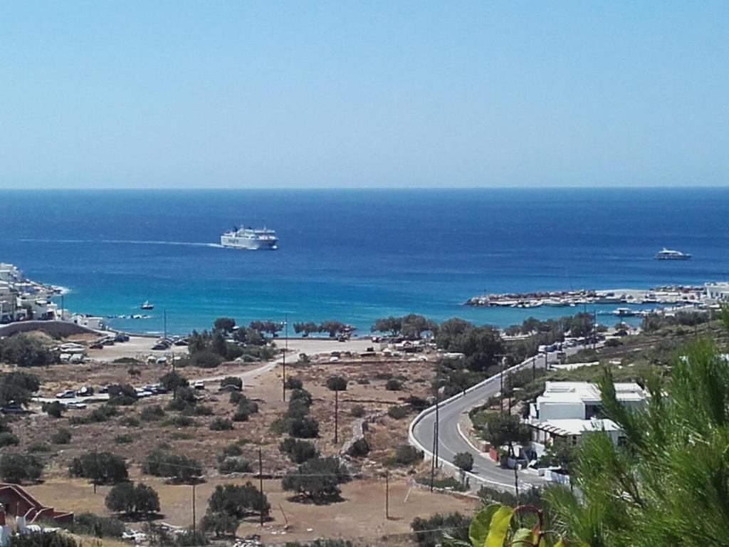 a cruise ship in the ocean next to a road at COSY STUDIO IN ALLOPRONOIA SIKINOS in Alopronia