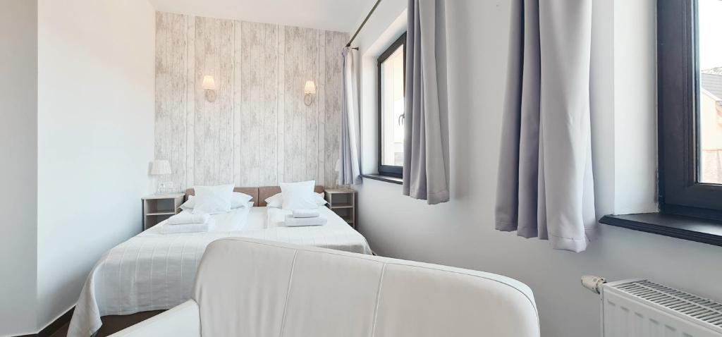 Posteľ alebo postele v izbe v ubytovaní Apartamenty Sasinówka