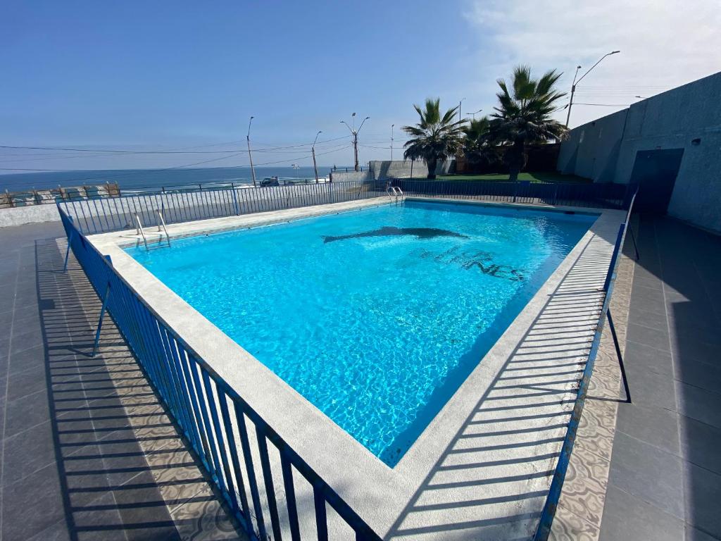 a large swimming pool with a fence around it at En Iquique, Chile, depto diario frente a playa Brava in Iquique