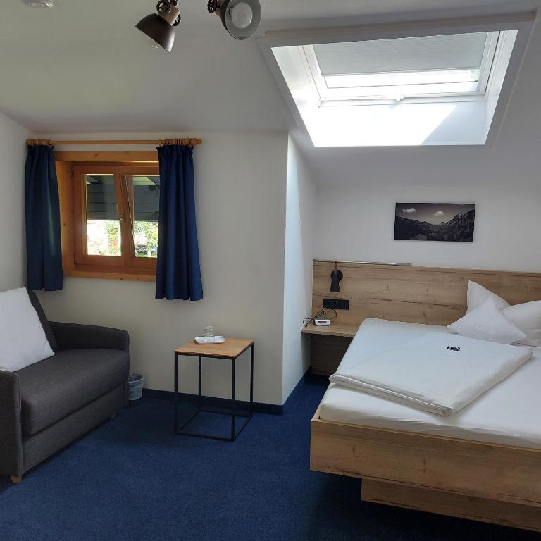 Postel nebo postele na pokoji v ubytování Hotel Garni Malerwinkl