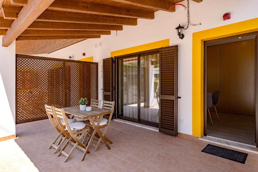 a dining room with a table and chairs on a patio at Quinta das Andorinhas in Carvoeiro
