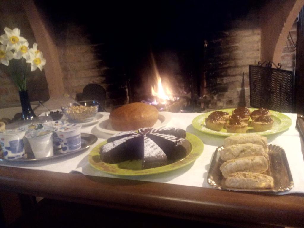 a table with cakes and pastries on top of it at Agriturismo La Crocetta in San Giovanni in Persiceto