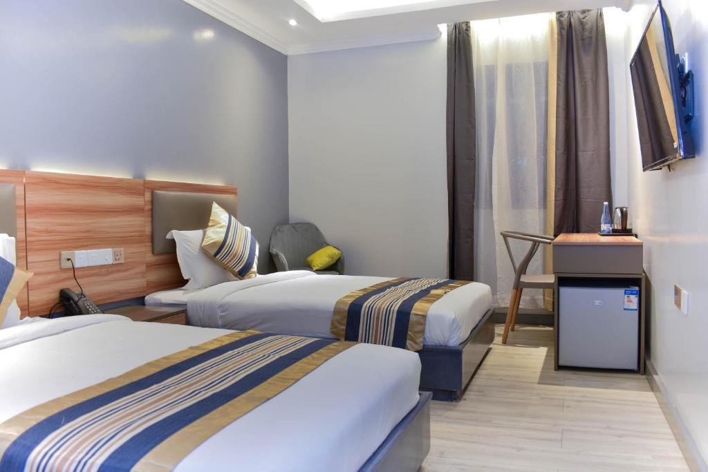 Postel nebo postele na pokoji v ubytování Raha Suites - Westlands