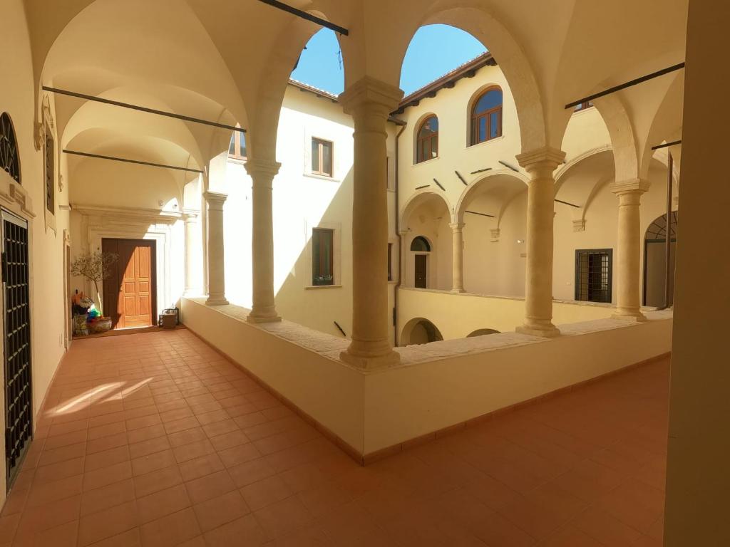 an empty hallway of an old building with arches at Tiny House Alferi in LʼAquila