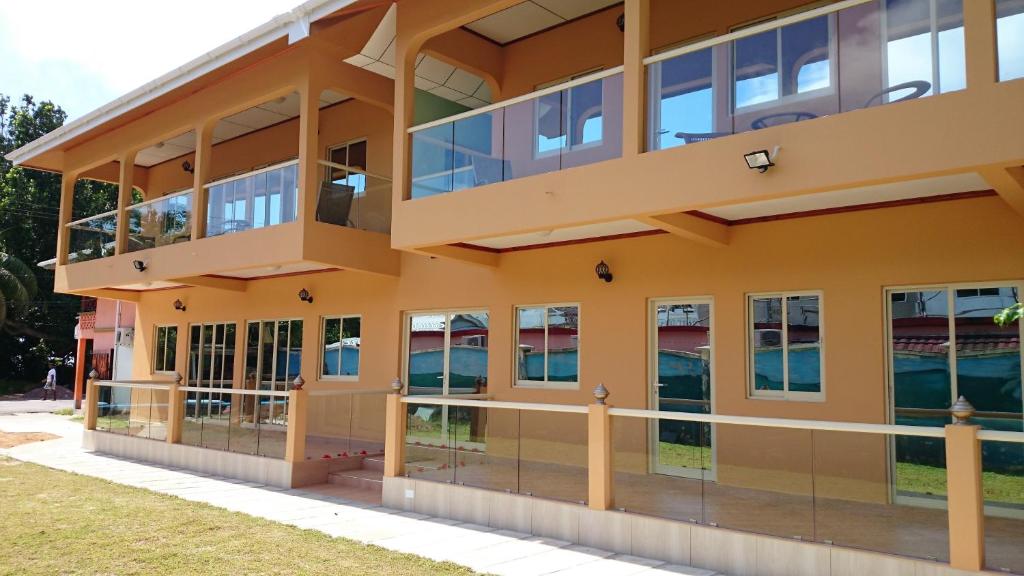 an exterior view of a building with large windows at Villa Bedier Self-catering Apartments in Baie Sainte Anne