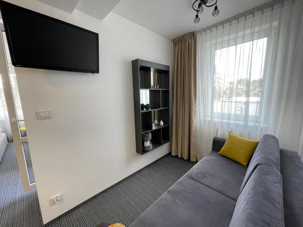 Televízia a/alebo spoločenská miestnosť v ubytovaní Apartament Planeta Mielno 114 Premium