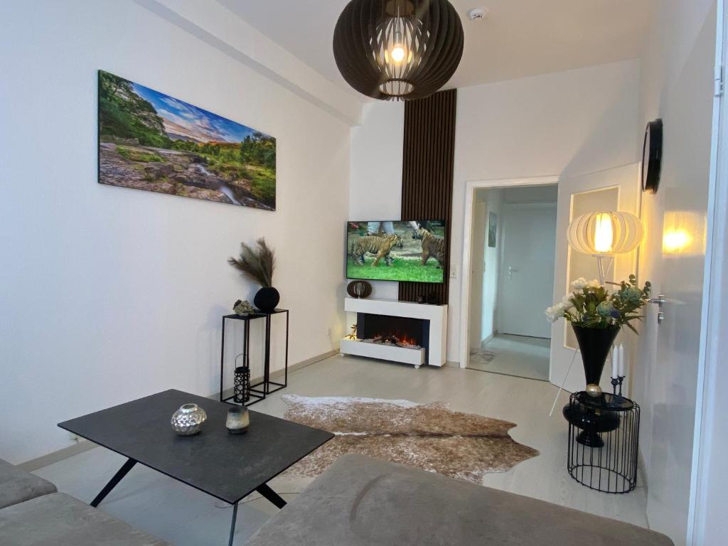 a living room with a couch and a tv at Ferienwohnung Univers 3 in Bad Harzburg