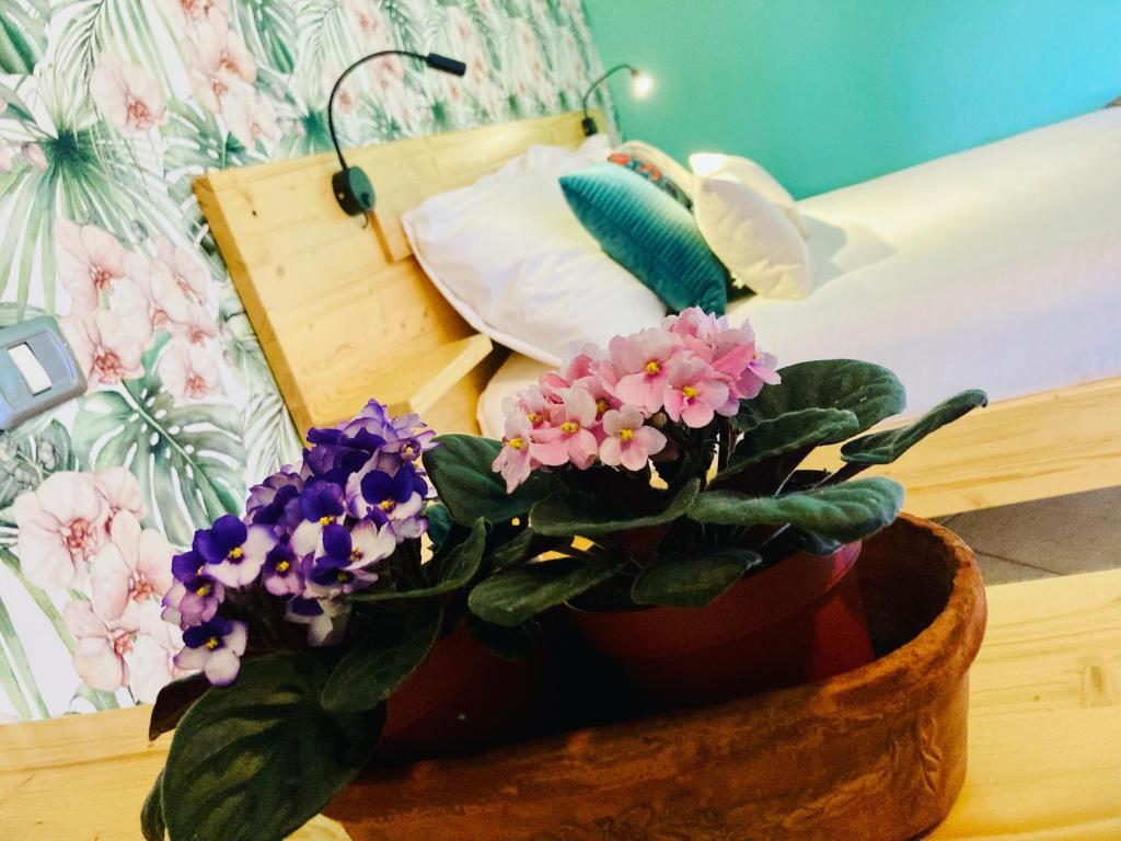 a potted plant sitting on a table next to a bed at Locanda del Borgo in Prunetto