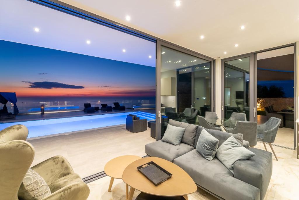 a living room with a large glass wall at Zenvillas in Agios Nikitas
