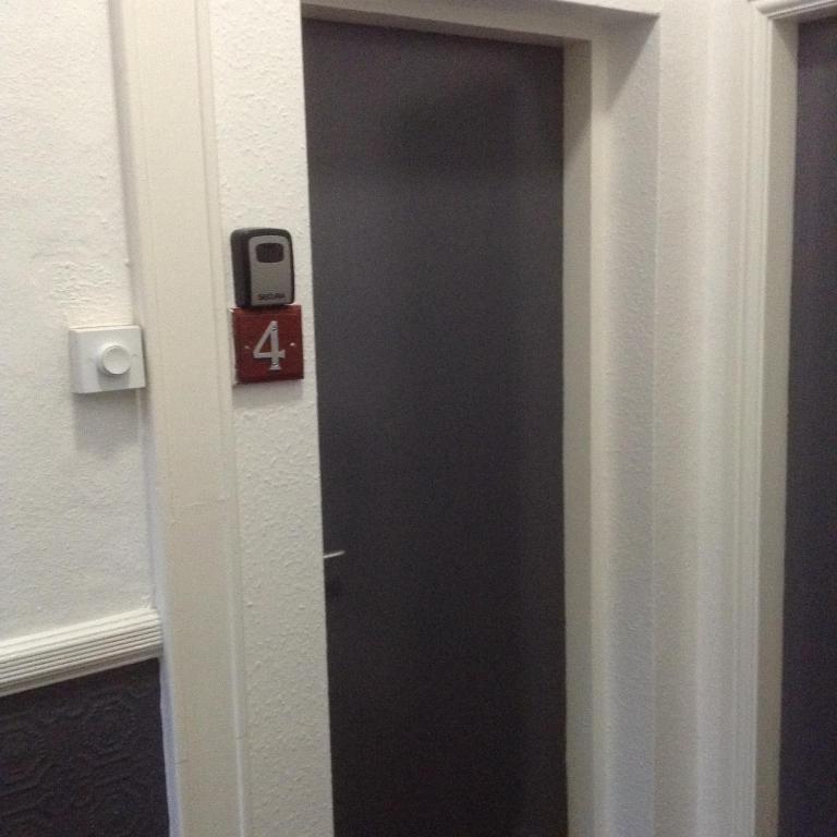 a door in a room with a sign on it at Marshfield Apartment in Goole