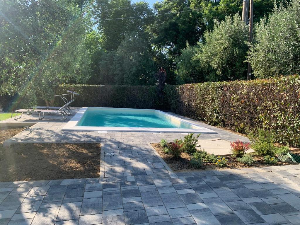 a swimming pool in a yard with a patio at Locazione turistica Casa olivo in Fucecchio