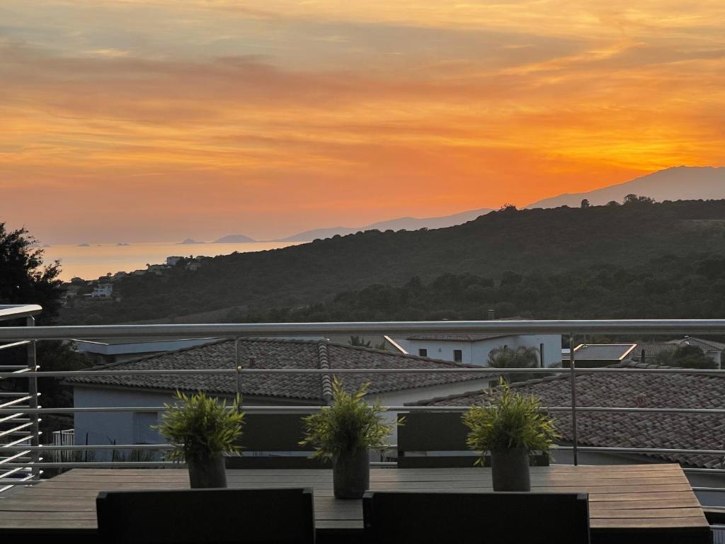 a sunset view from the roof of a building at Coucher de soleil in Porticcio