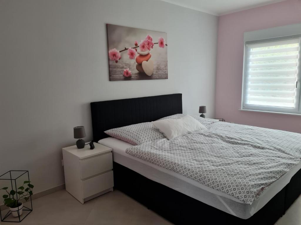 a bedroom with a bed and a window at Ferienhaus an der Saar in Merzig