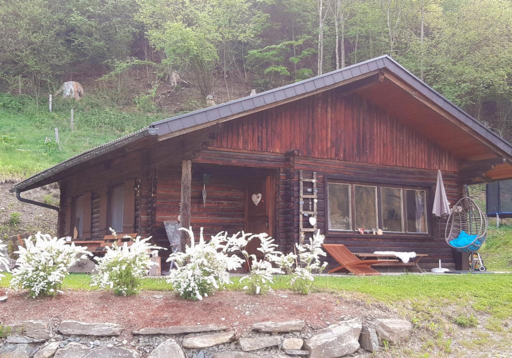 a log cabin with a table and a bench in front of it at Ferienhaus Spitzer in Feldkirchen in Kärnten