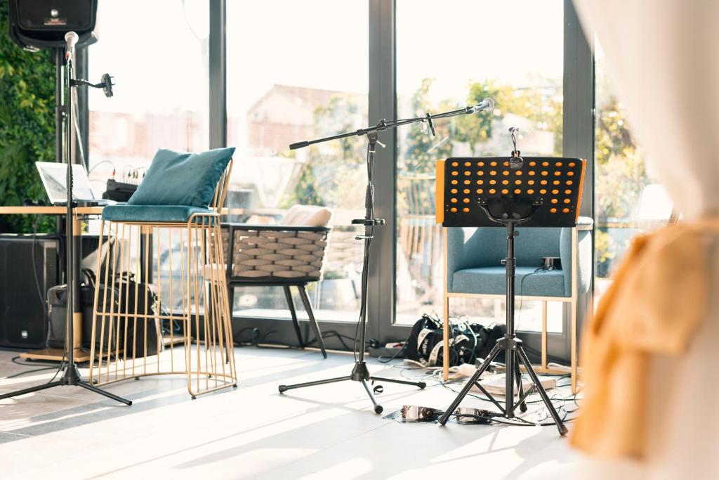 a recording studio with a microphone and chairs at Hotel Millennium by Aycon in Budva