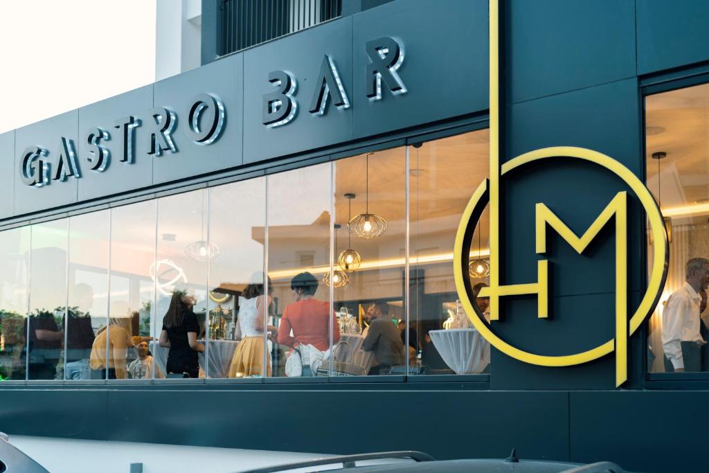 a store with a sign on the side of a building at Hotel Millennium by Aycon in Budva