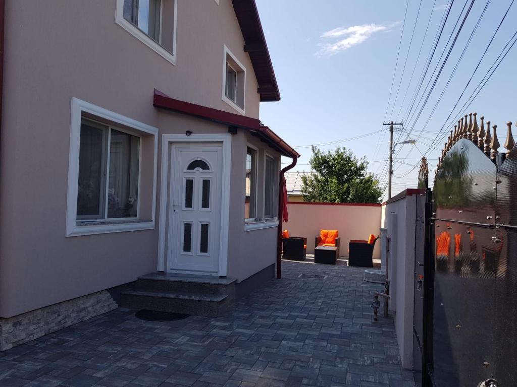 a building with a white door on the side of it at "Apartament"-Casa Genius in Ploieşti