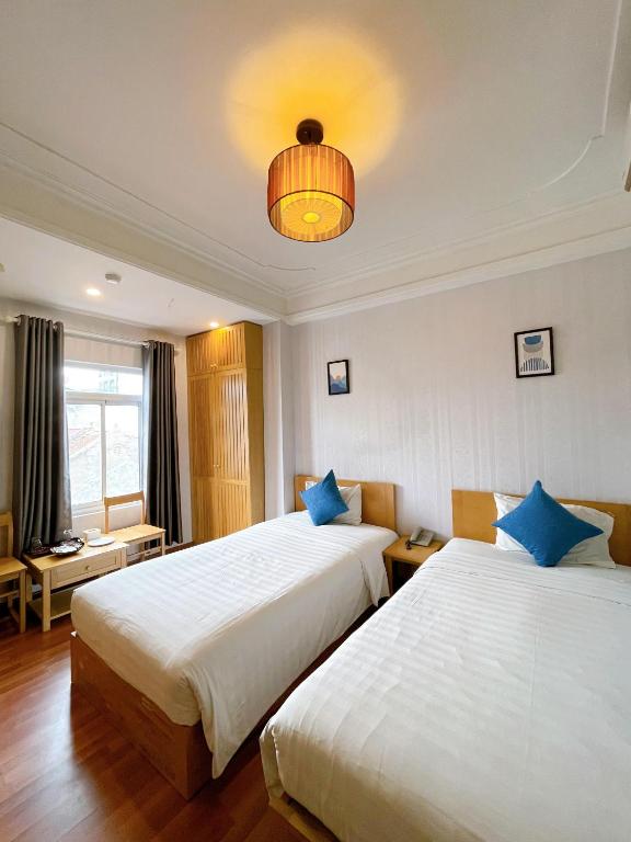 Postel nebo postele na pokoji v ubytování Hanoi Central Park Hotel