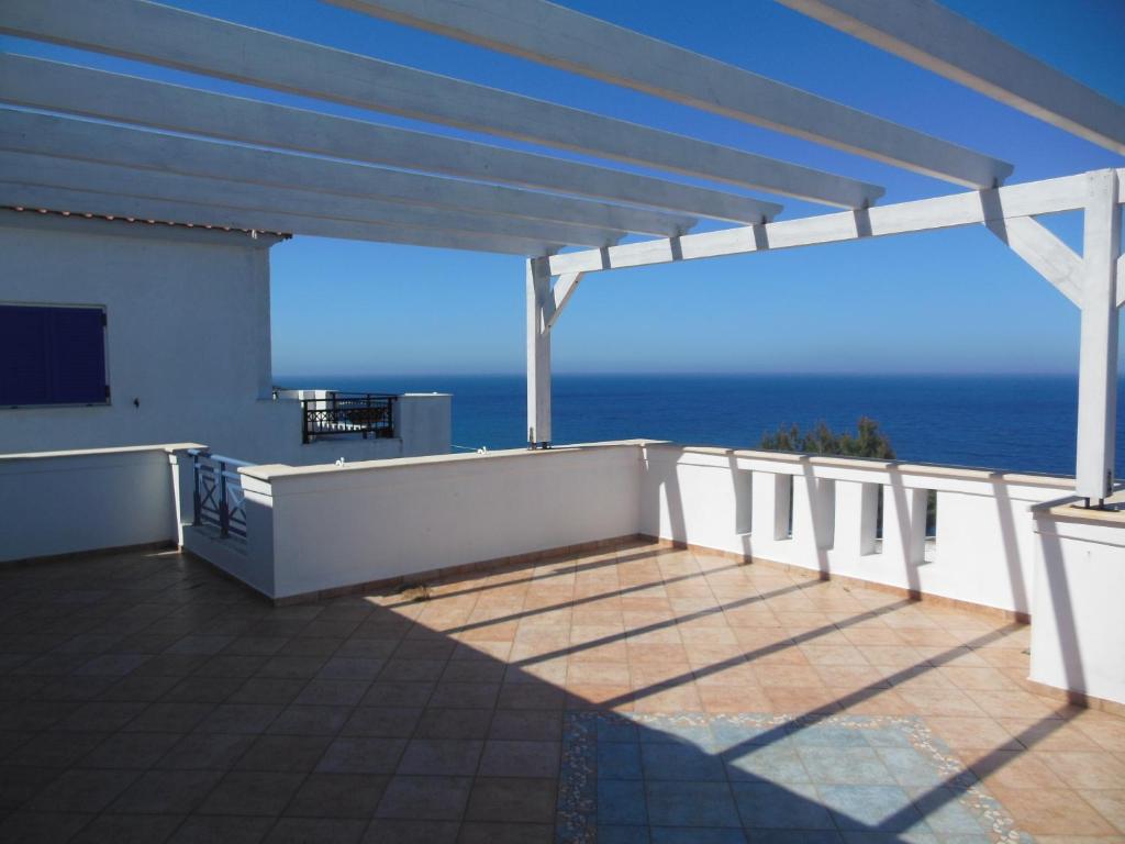 a balcony with a view of the ocean at SUNSET APARTMENTS in Évdhilos