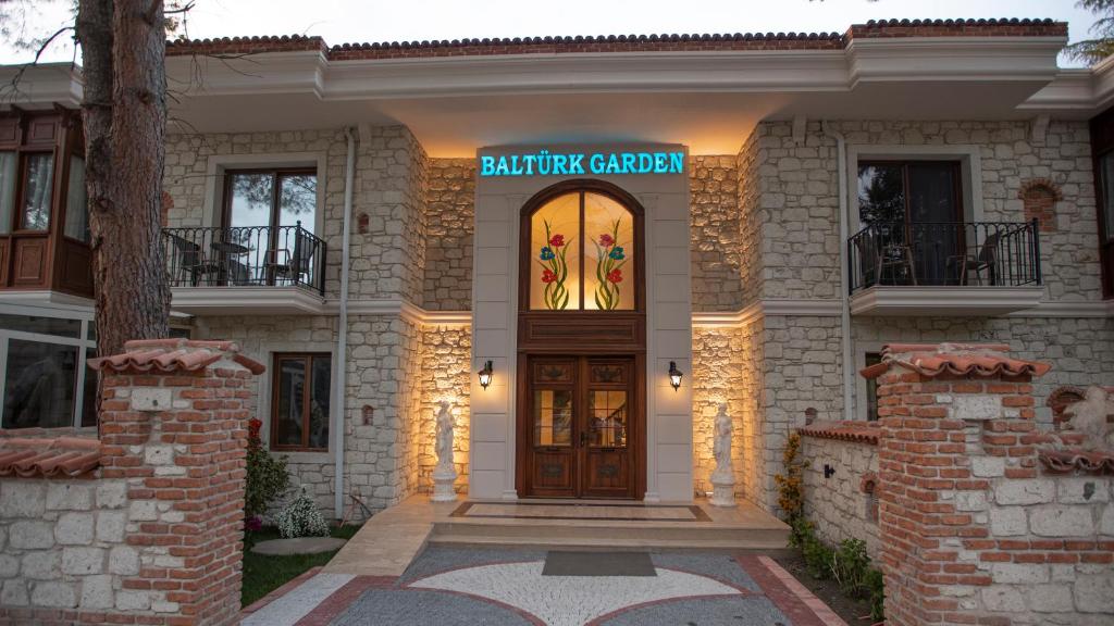 a house with a sign on the front of it at Balturk Garden Sapanca Hotel in Sapanca