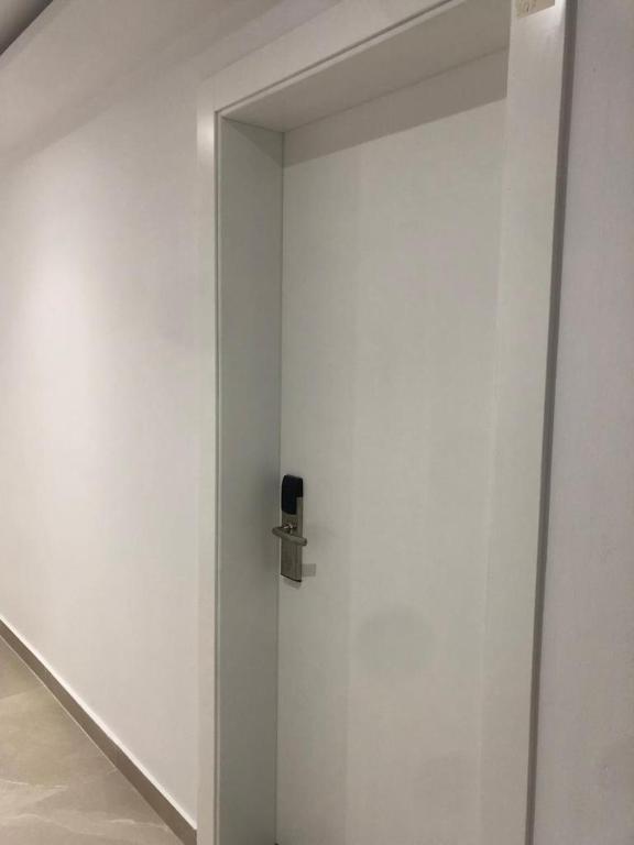 a white door with a door knob on a wall at Hotel MARIO, Shengjin in Shëngjin