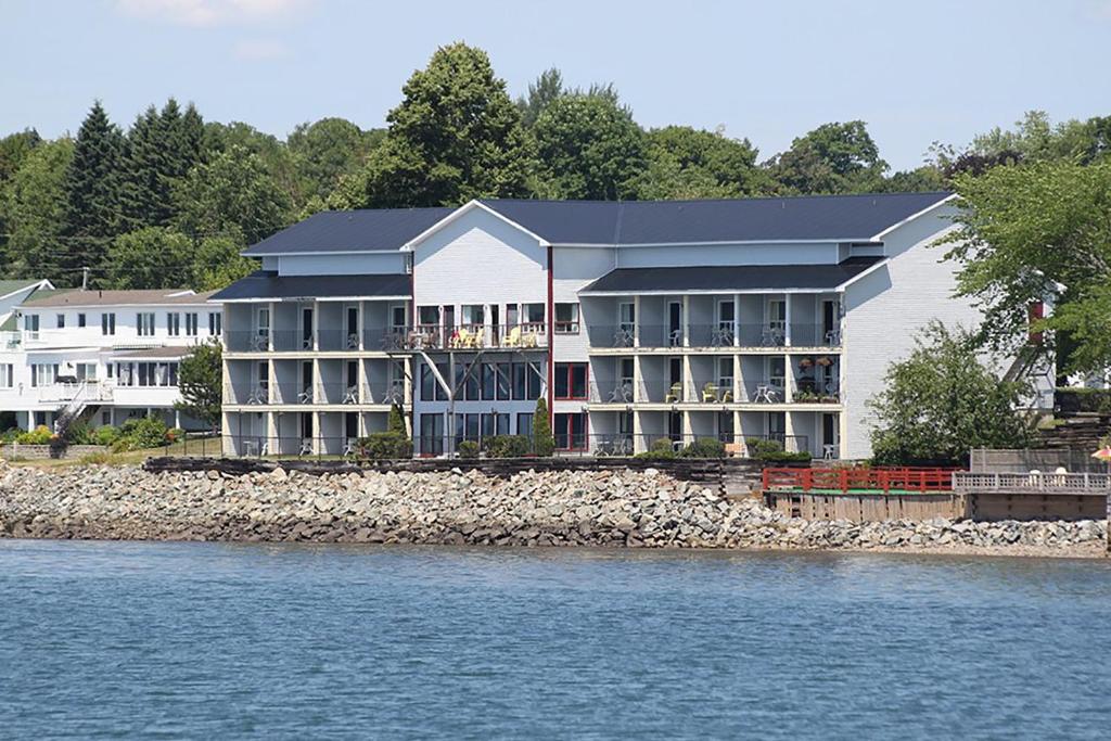 a large building next to a body of water at St Andrews Inn & Suites in Saint Andrews